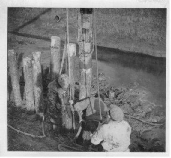Historic image circa. 1947: men work with an old piling machine at the Lawyers sluice, South Holland IDB.