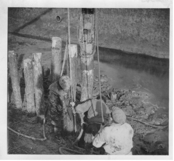 Historic image circa. 1947: men work with an old piling machine at the Lawyers sluice, South Holland IDB.